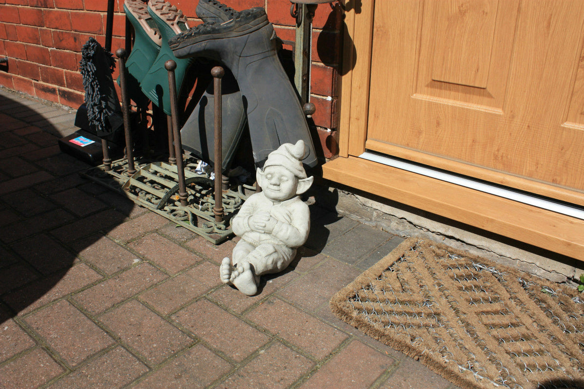 Garden Gnome Ornament - Relax outdoors | Durable & Antique Finish, placed by front door on patio, perfect for welcoming outdoor decoration.