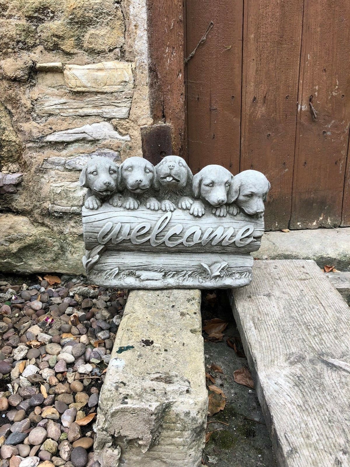 Front-facing view of stone welcome puppies sculpture, perfect for adding a warm, decorative touch to garden entrances.