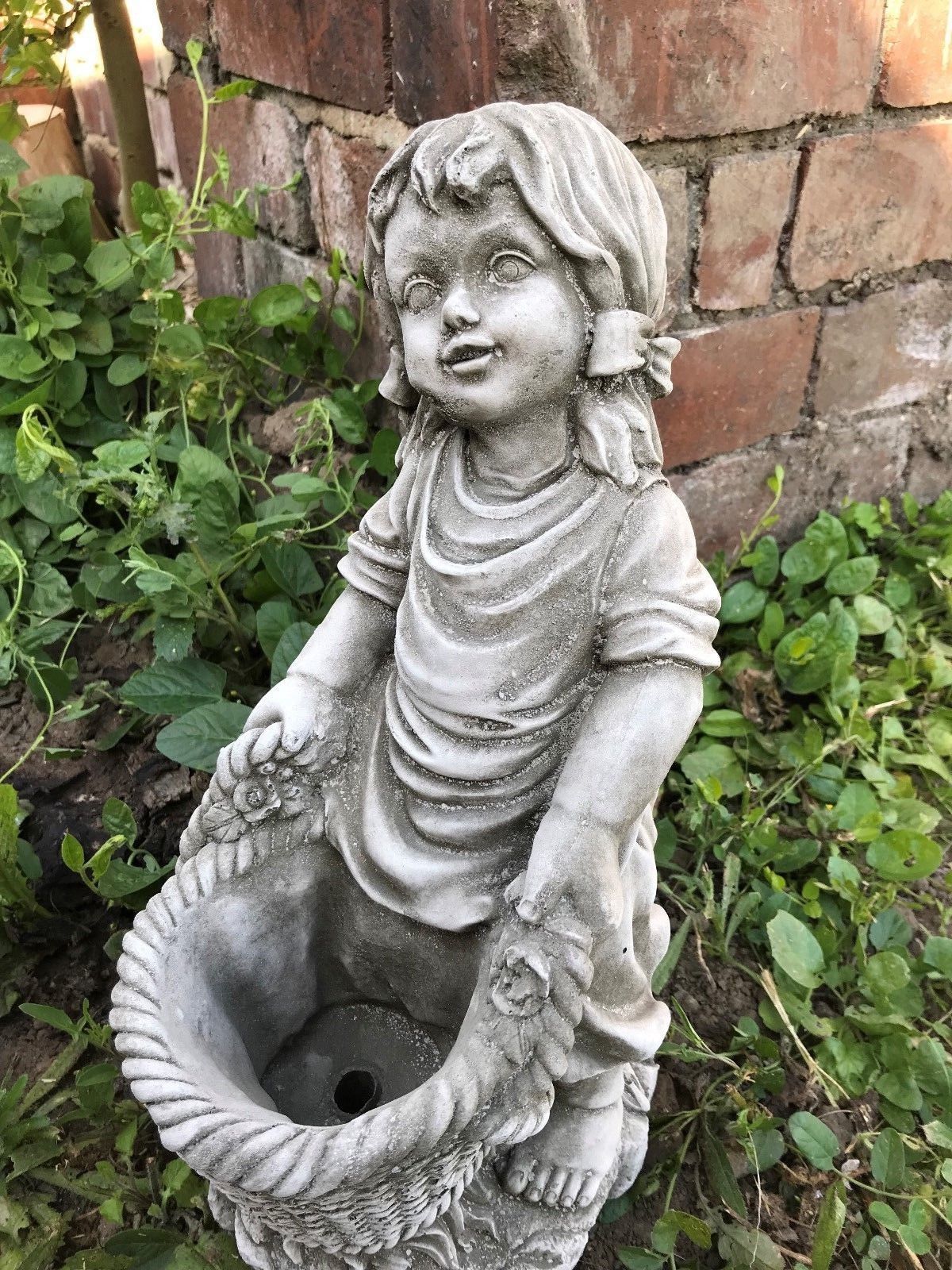 Close-up of the Stone Basket Girl Garden Planter Ornament with antique grey finish, perfect for adding charm to garden or patio spaces.
