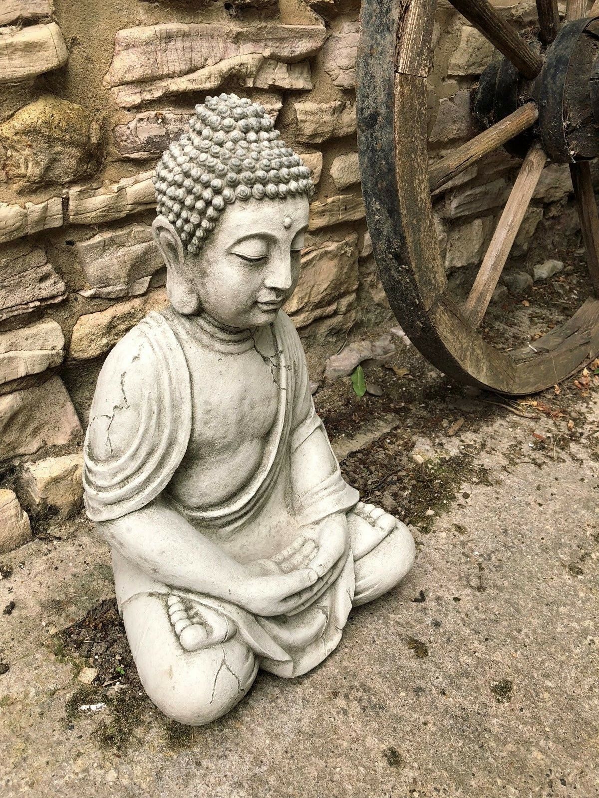 Side view of Meditating Buddha Statue in stone, showcasing detailed craftsmanship and aged texture, perfect for garden ornamentation.
