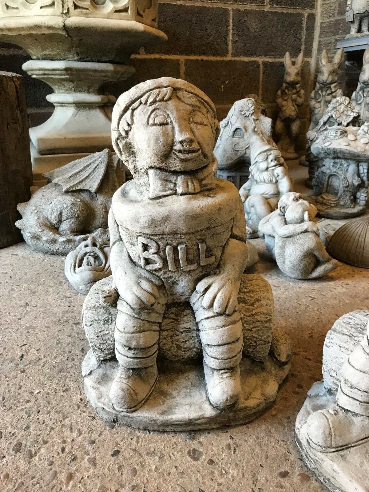 Close-up of the Stone Bill statue, featuring detailed carving and antique limestone finish, perfect for garden or patio decoration.