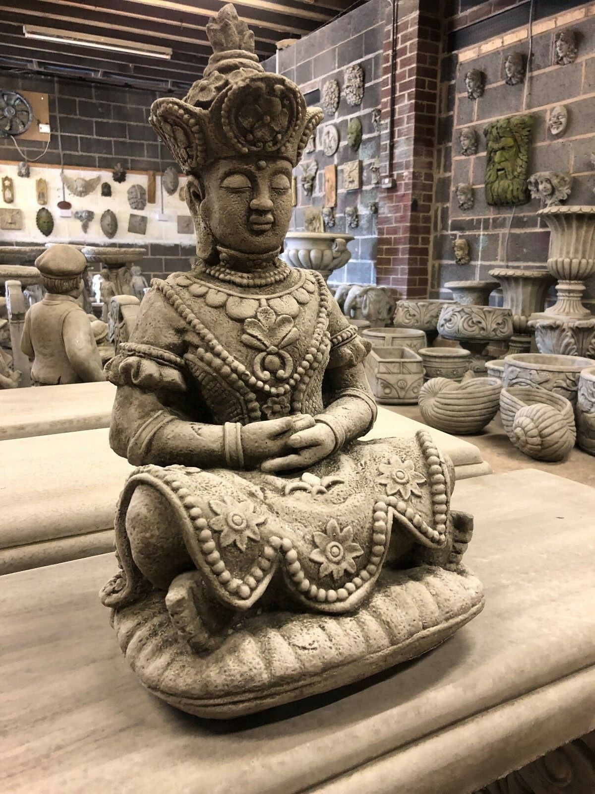 Serene Buddha Statue Garden - Meditating Stone | Peaceful Decor. Side view of ornate stone Buddha sculpture, ideal for outdoor meditation spaces.