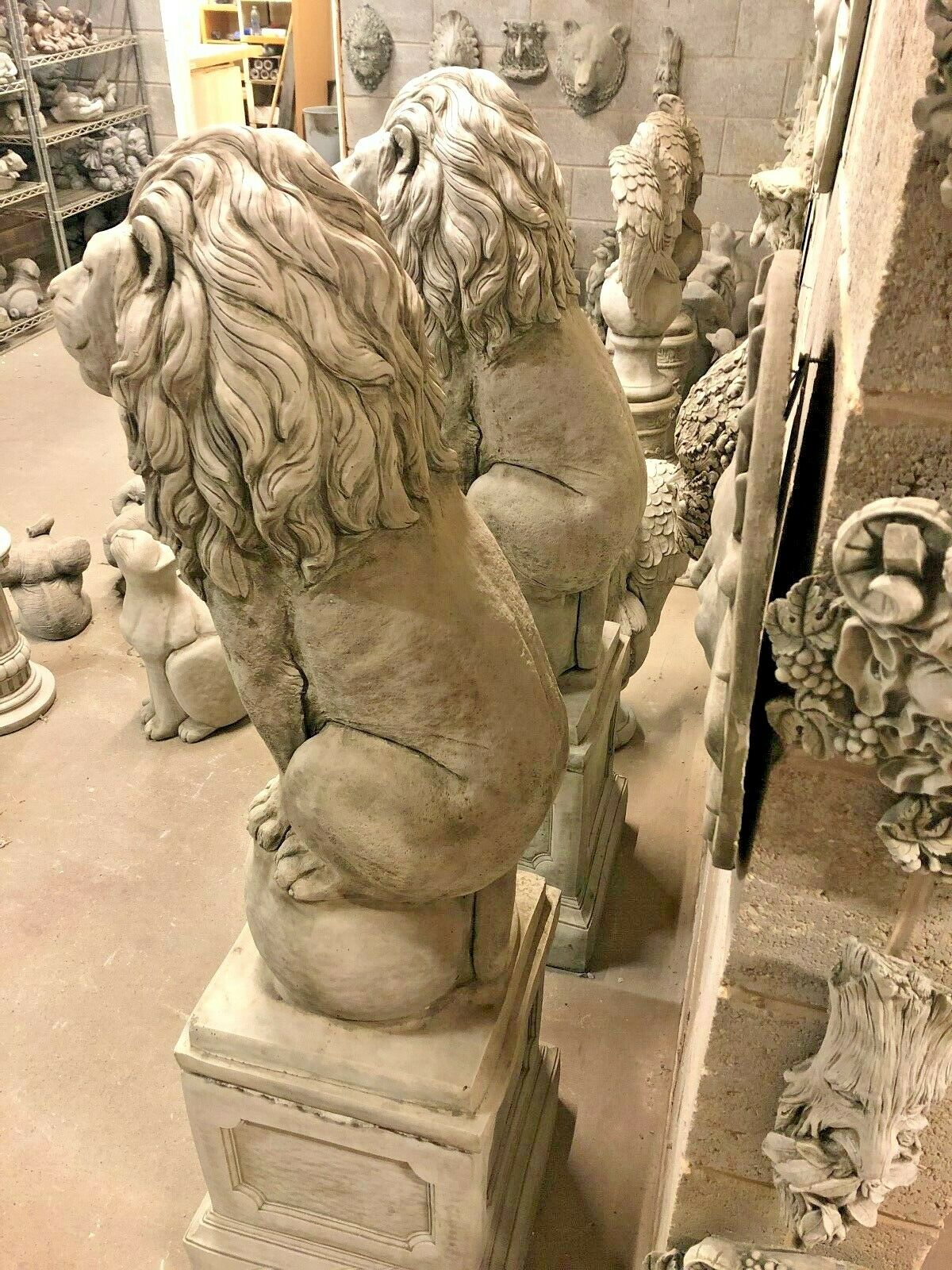 Side view of limestone lion garden statues showing detailed mane and muscular build, perfect for outdoor decorative use in luxury landscapes.