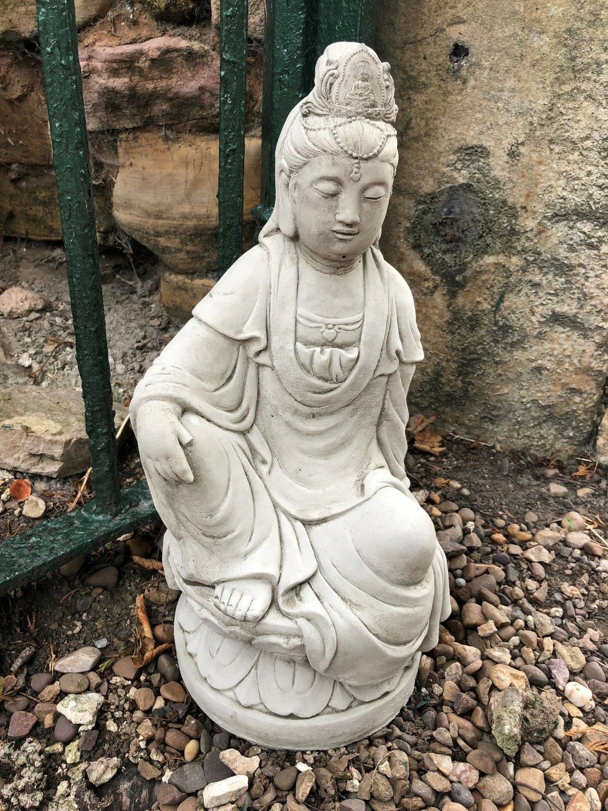 Detailed Kuan Yin garden ornament in weather-resistant stone, ideal for patios or Zen gardens. 18" tall limestone sculpture with serene expression.