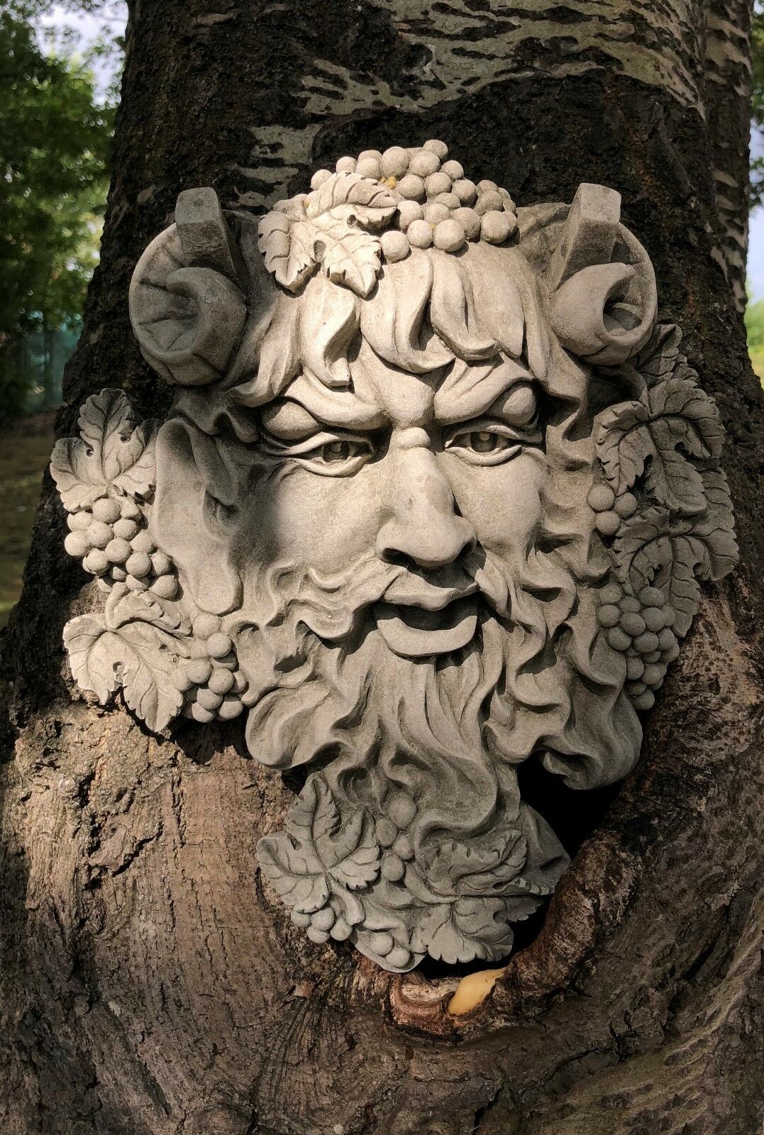 Detailed Bacchus Face Garden Plaque with grapevine and horn motifs, antique stone wall hanging perfect for enhancing rustic garden aesthetics.