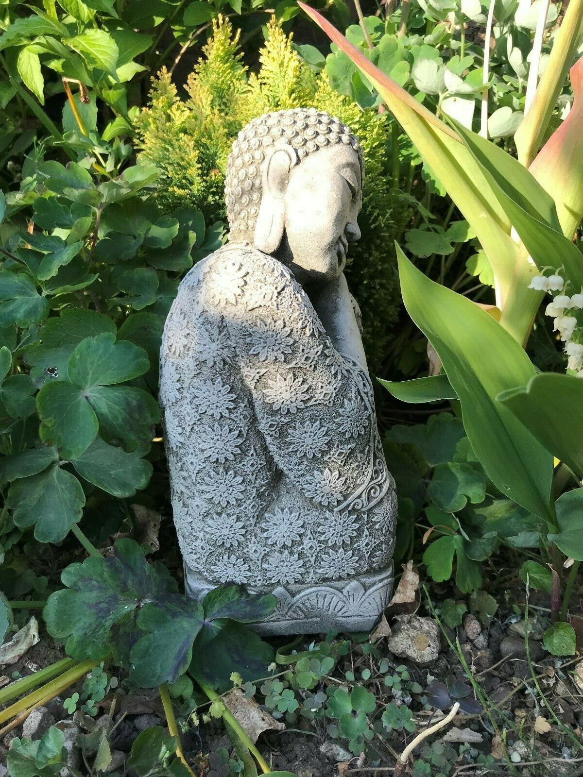 Side view of detailed Stone Sleeping Buddha Statue with floral carvings, perfect for tranquil garden decoration and outdoor meditation spaces.
