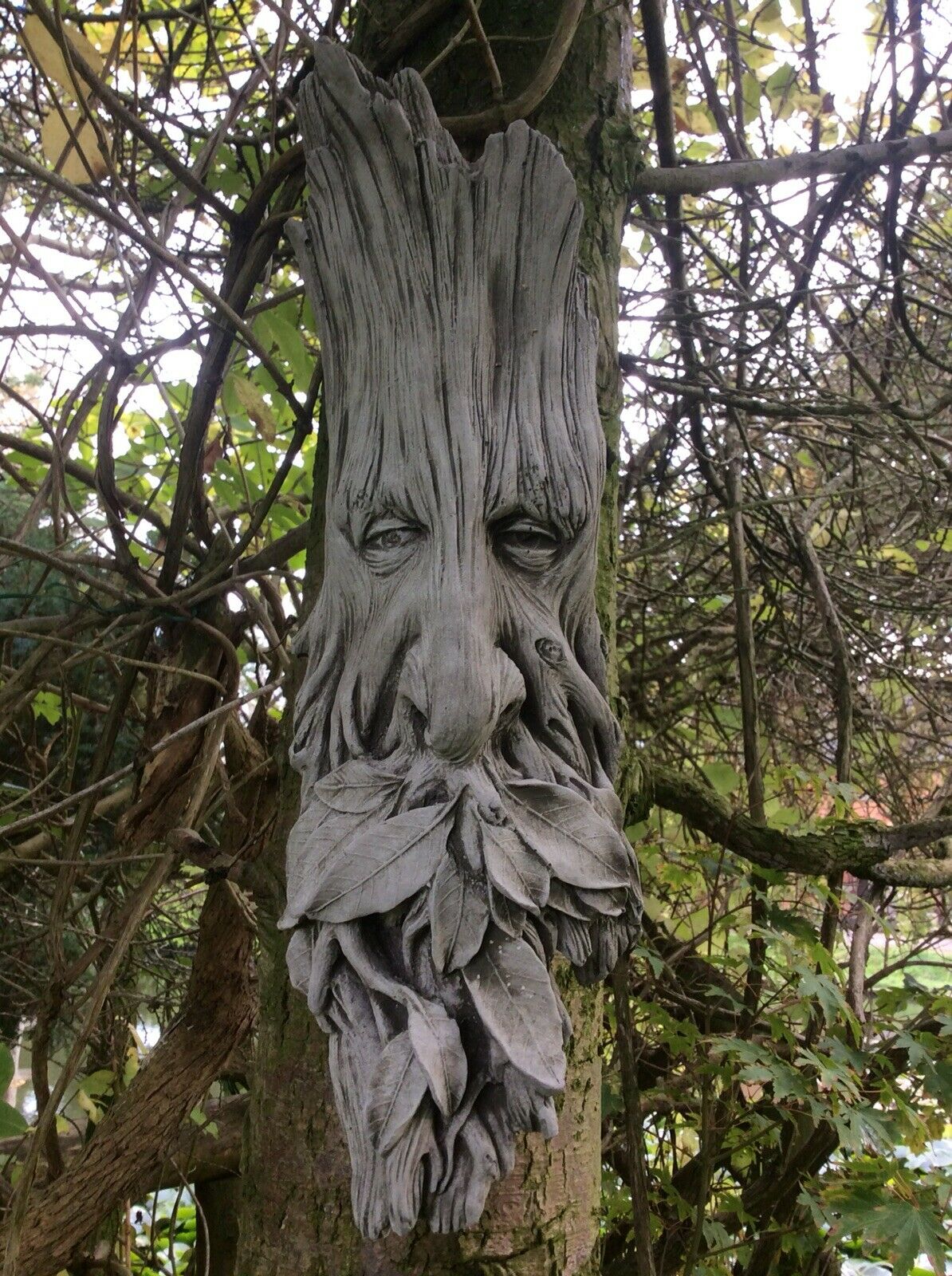 Stone Leaf Greenman Plaque with weathered wood texture and intricate leaf design, perfect for enhancing garden ambiance.