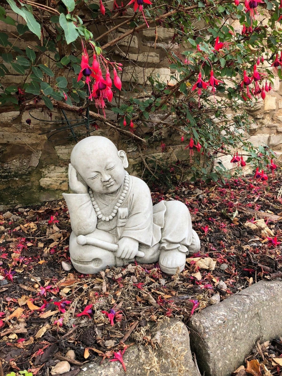 Handcrafted Stone Resting Monk Sculpture Garden Ornament in serene pose, made from durable limestone for patios, gardens, or feng shui settings.