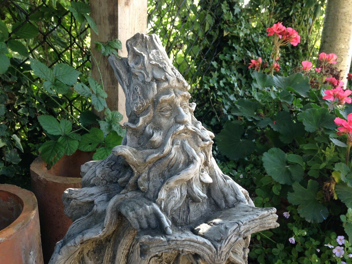 Close-up of Wizard Garden Statue's face and book, showcasing fine craftsmanship for enchanting garden decoration.