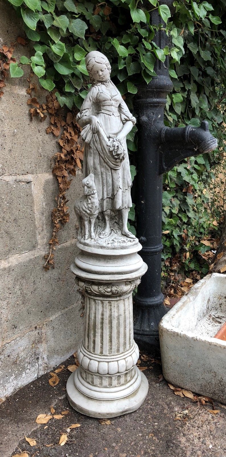 Full view of Stone Garden Shepherdess Statue on pedestal, 59cm tall, perfect for lawn ornament or patio sculpture centerpiece.