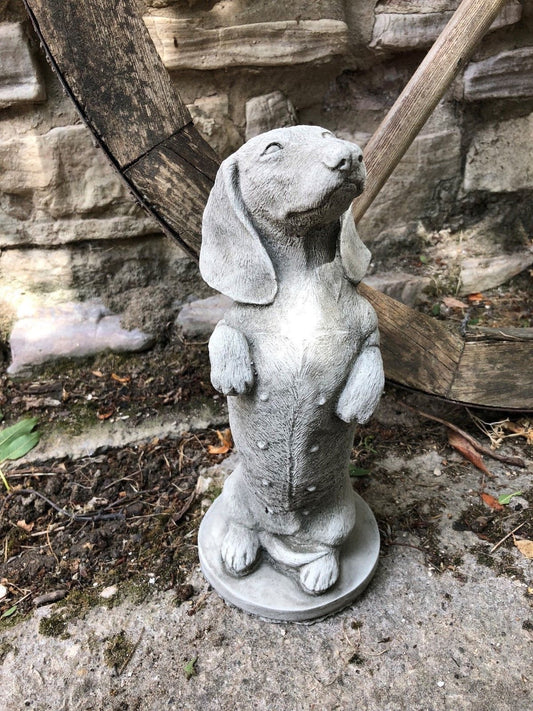 Stone dachshund sculpture with a begging pose, ideal for garden decor. Durable limestone finish suits outdoor patios and flower beds.