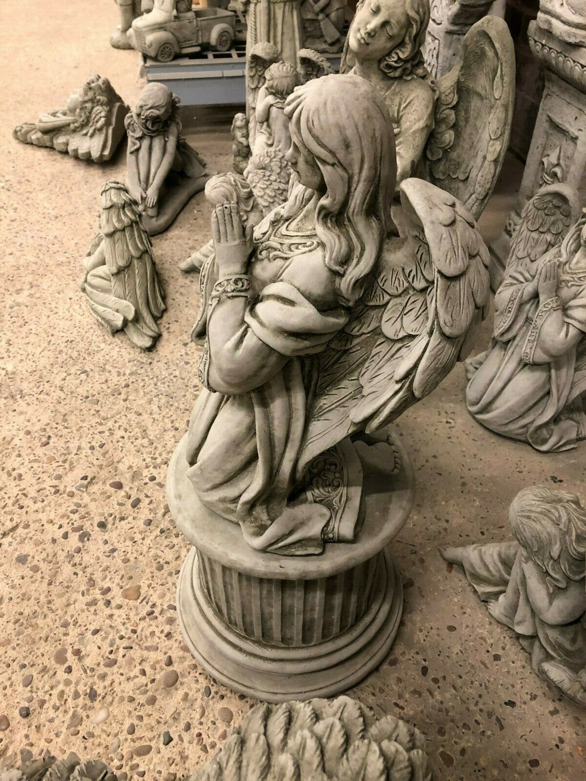 Angled view of Durable Stone Praying Angel Statue with flowing hair and folded hands. Ideal for enhancing outdoor spaces with spiritual decor.