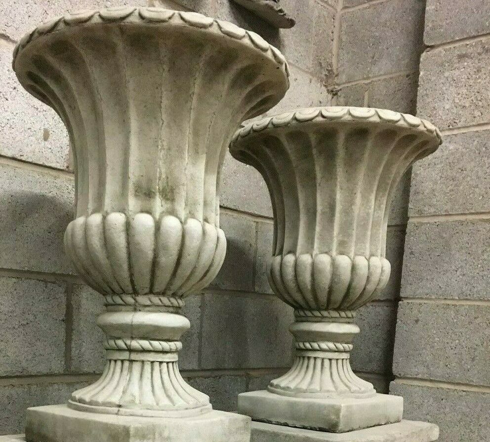 Angled view of antique grey Stone Georgian Urn Planters with classic fluted design, perfect for enhancing outdoor garden aesthetics.