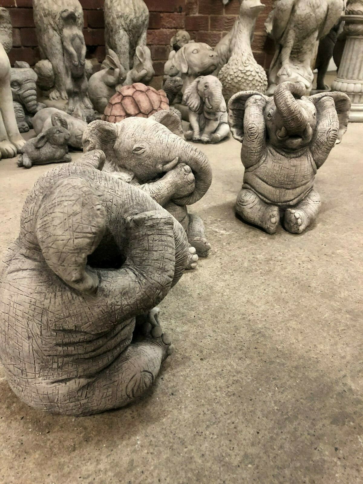 Angled view of Elephant Ornaments - Hear, See & Speak No Evil set, perfect for enhancing garden aesthetics with animal-themed stone sculptures.