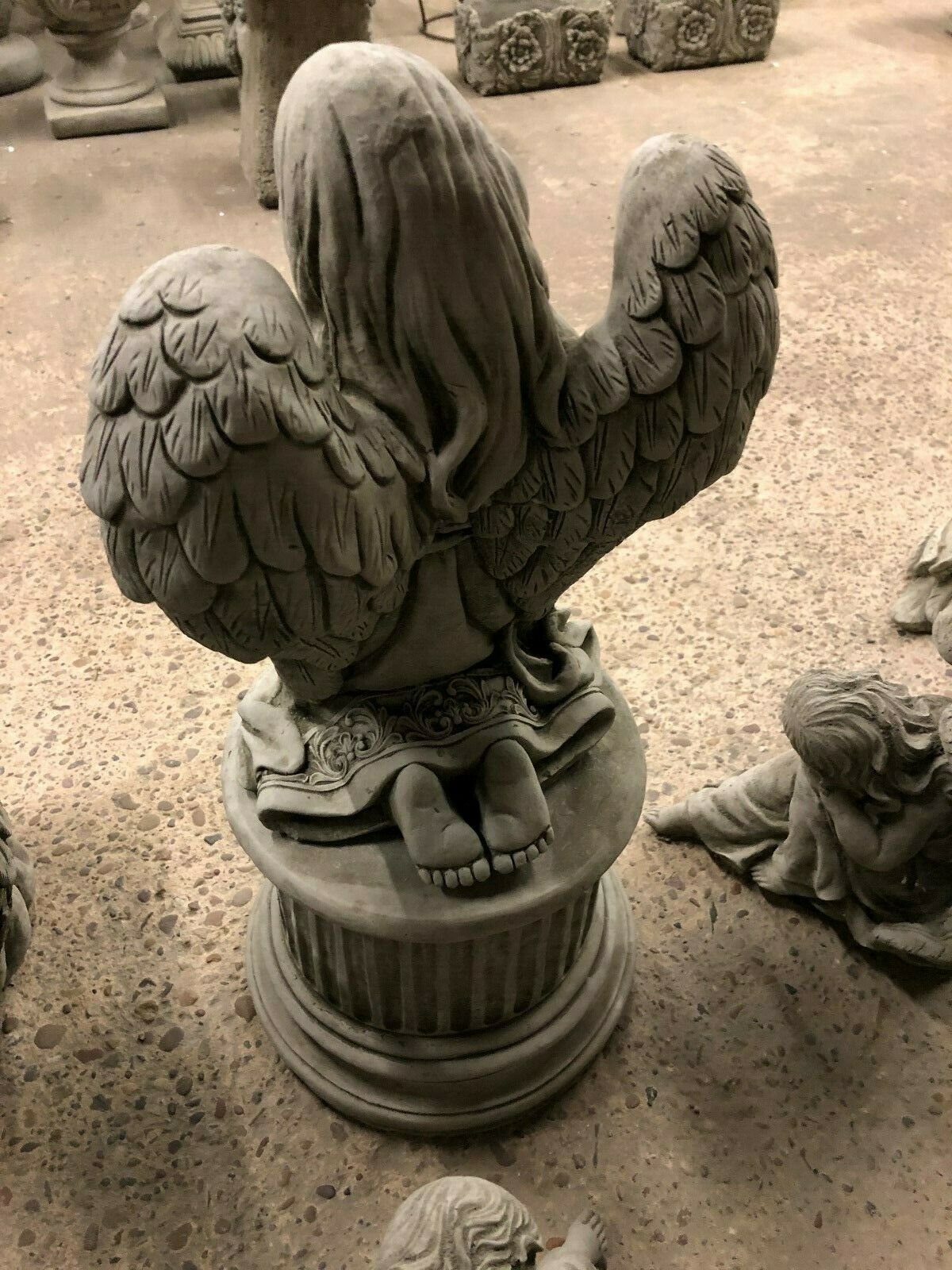 Rear view of Durable Stone Praying Angel Statue showing detailed feathered wings and base. Weather-resistant design for lasting garden beauty.