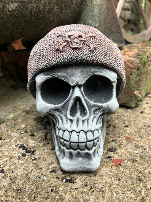 Stone Skull Beanie Ornament with detailed teeth and eye sockets, ideal for garden decor. Features a textured knit-style beanie with skull emblem.