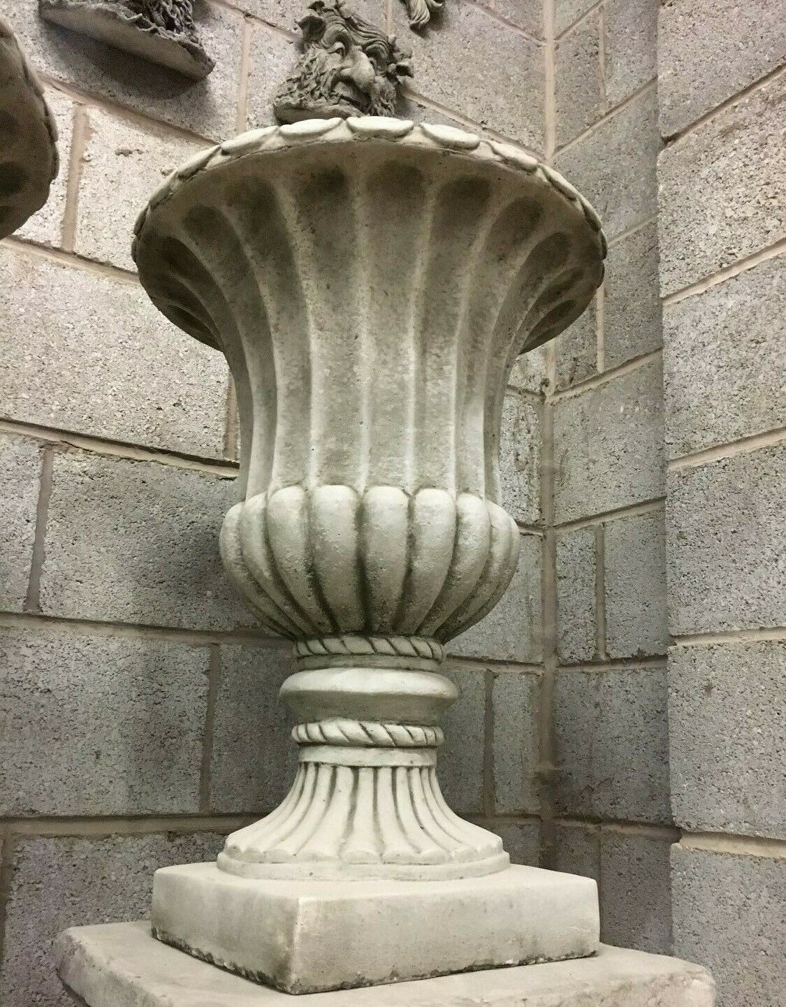 Tall Stone Urn Planter in Georgian design with detailed fluting and pedestal base, made from durable antique grey limestone.