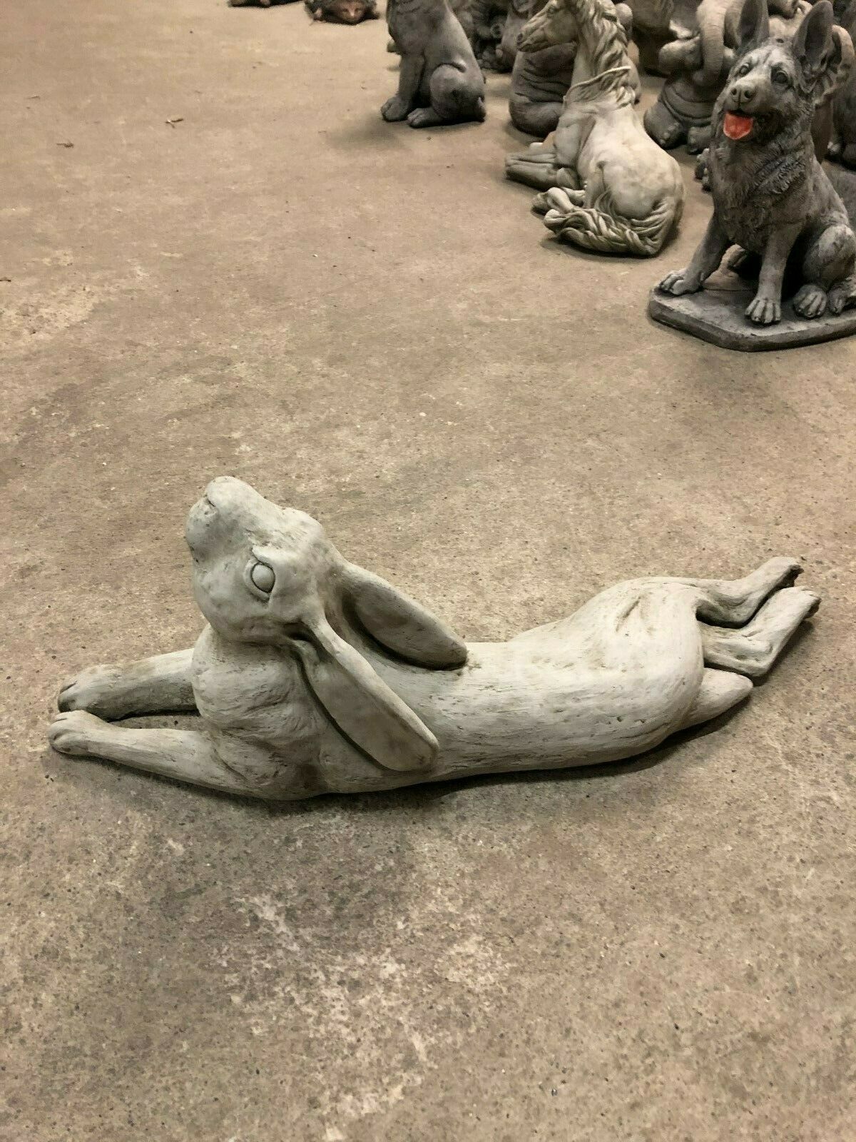 Detailed Stone Hare Garden Ornament in laying position, suitable for outdoor decor in home gardens or patios.