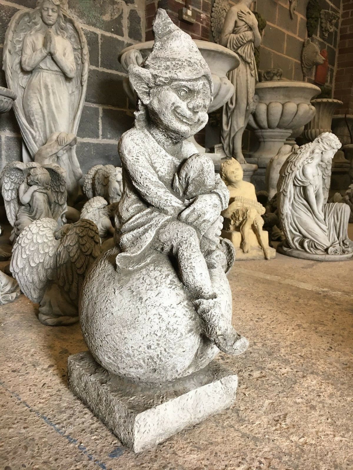 Stone Pixie on Ball Statue - Weatherproof Decor | Durable side view of detailed limestone pixie sculpture, ideal for outdoor garden settings.