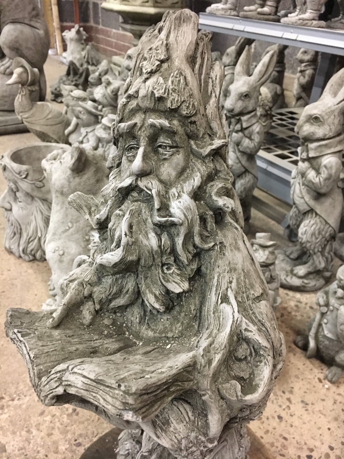 Close-up of Wizard Garden Statue holding an open book, ideal for storytelling-themed garden decor.