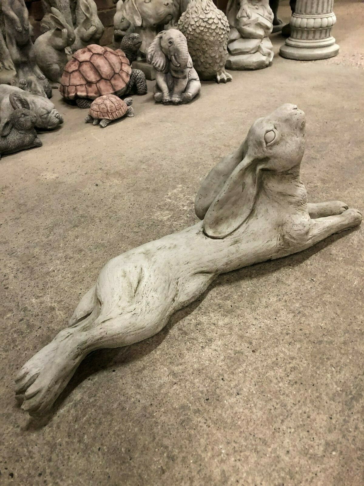 Side angle of Stone Hare Garden Ornament with antique finish, designed for outdoor durability and decorative appeal.