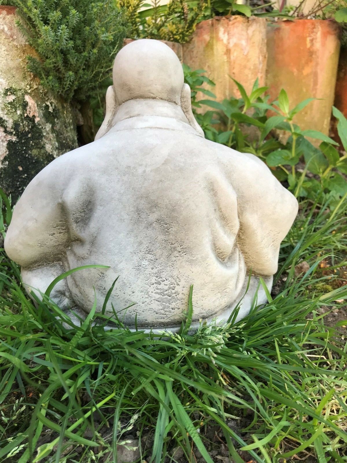 Rear view of Stone Laughing Buddha Ornament highlighting the smooth limestone texture, suitable for outdoor garden sculpture.