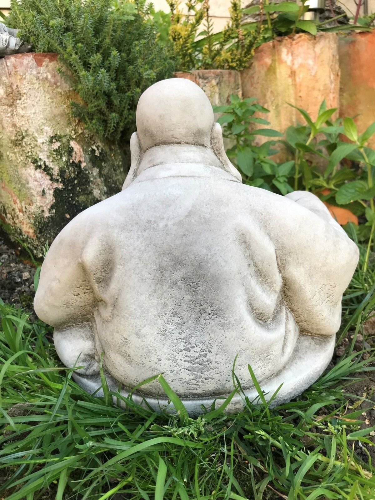 Backside of Stone Laughing Buddha Ornament with detailed robe folds, ideal for enhancing peaceful garden environments.