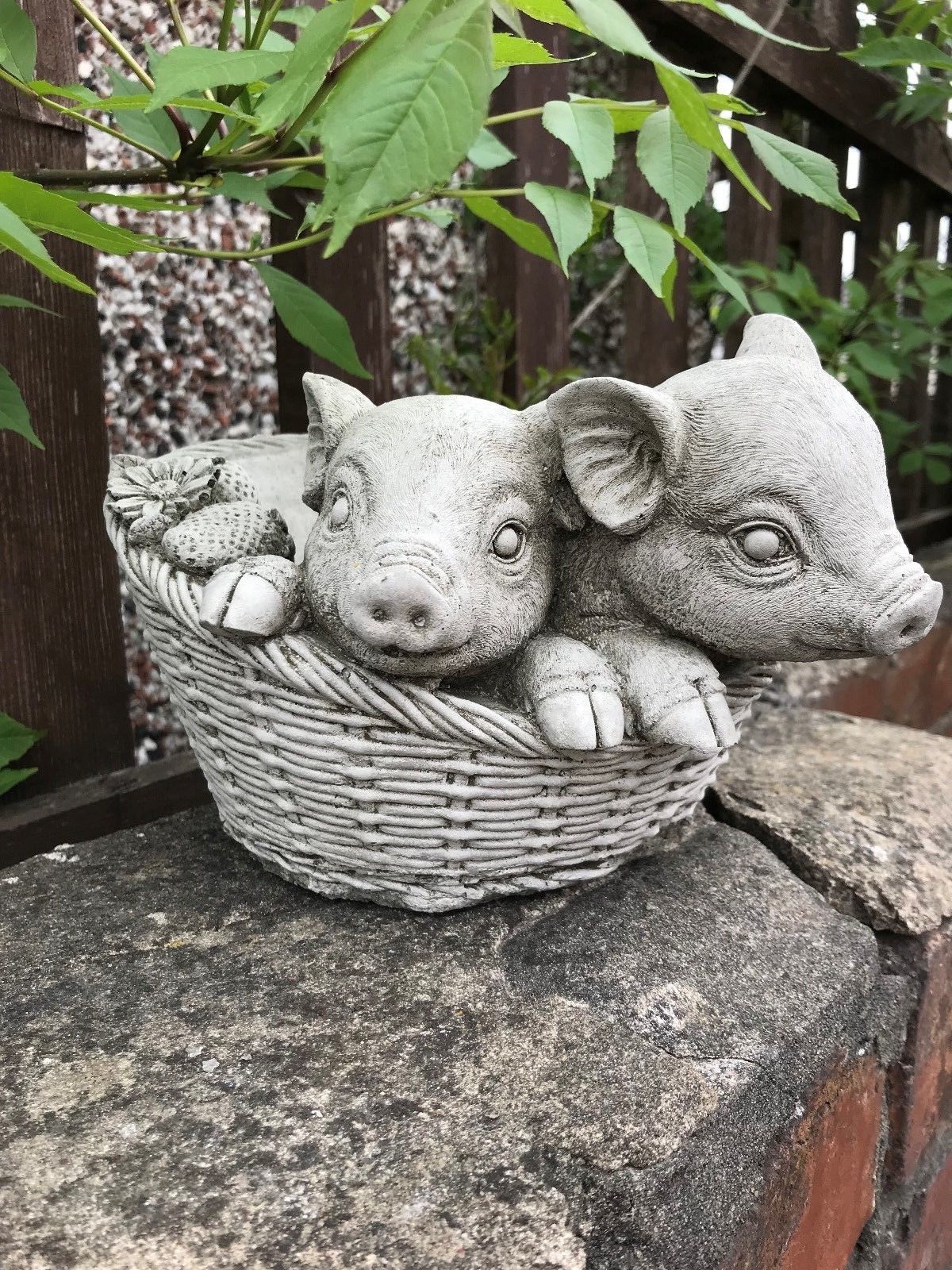 Durable stone pig planter ornament with lifelike piglet faces and basket texture. Ideal for outdoor garden decoration and plant display.