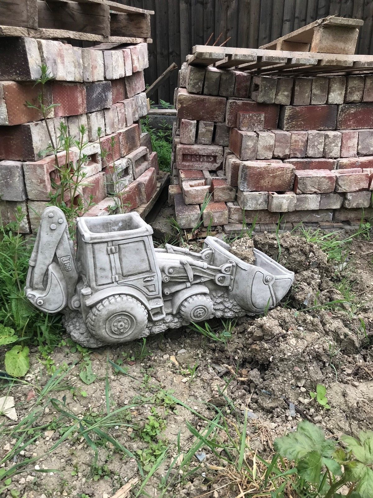 JCB Shovel Digger Planter - Garden Feature | Heavy & Durable garden ornament in the shape of a JCB digger, set in a rustic outdoor setting.