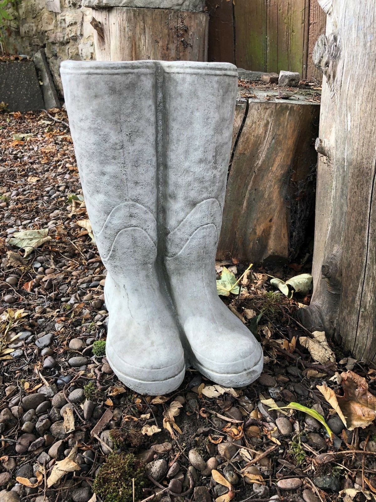 Detailed Stone Wellington Boots Planter with realistic boot texture, ideal for garden decoration and plant display on natural stone surface.