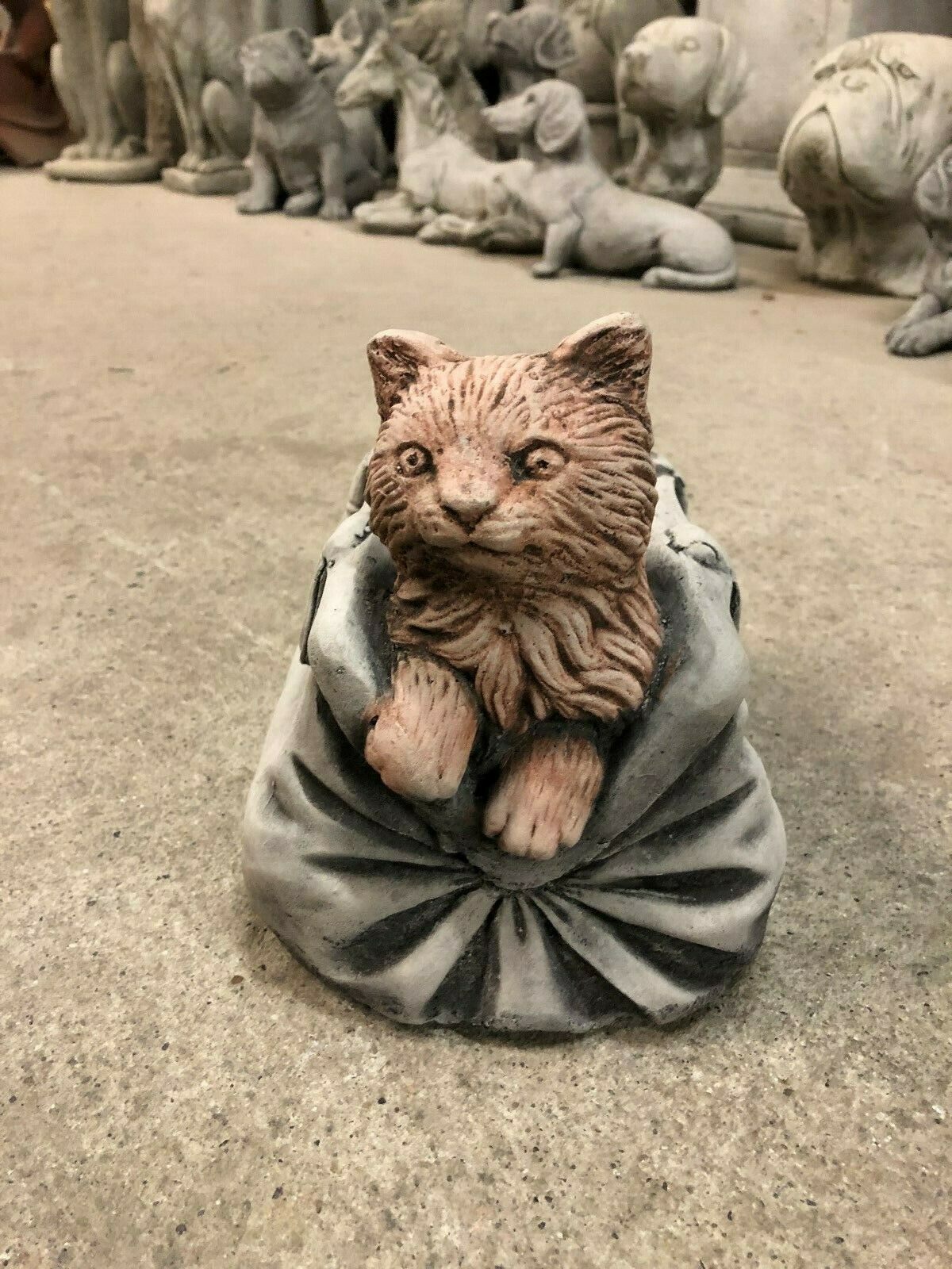 Antique-style Stone Cat In Bag Planter with lifelike feline figure and realistic handbag design, perfect for garden or patio decoration.