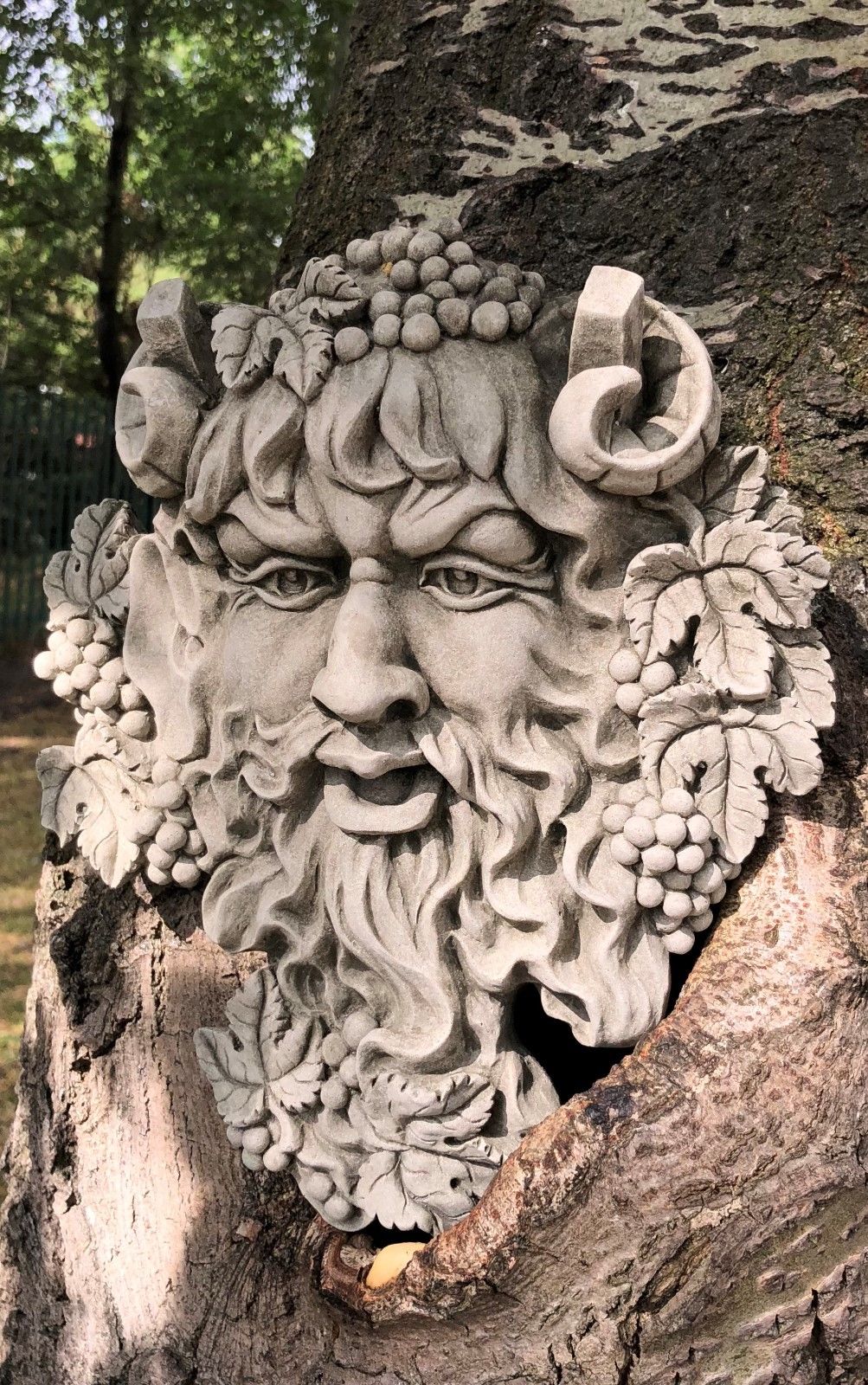 Side view of Bacchus Face Garden Plaque - Wall Hanging, showcasing intricate leaf and grape detailing in antique stone for garden or patio walls.