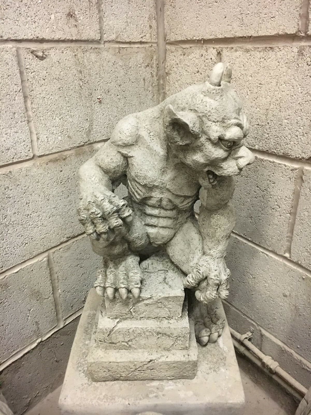 Detailed close-up of stone gargoyle statue's face with textured limestone finish, ideal for gothic garden or lawn ornamentation.