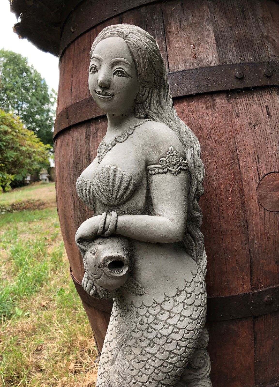 Close-up of Mermaid Water Feature Ornament showing facial detail and fish spout, crafted for garden or patio water displays.