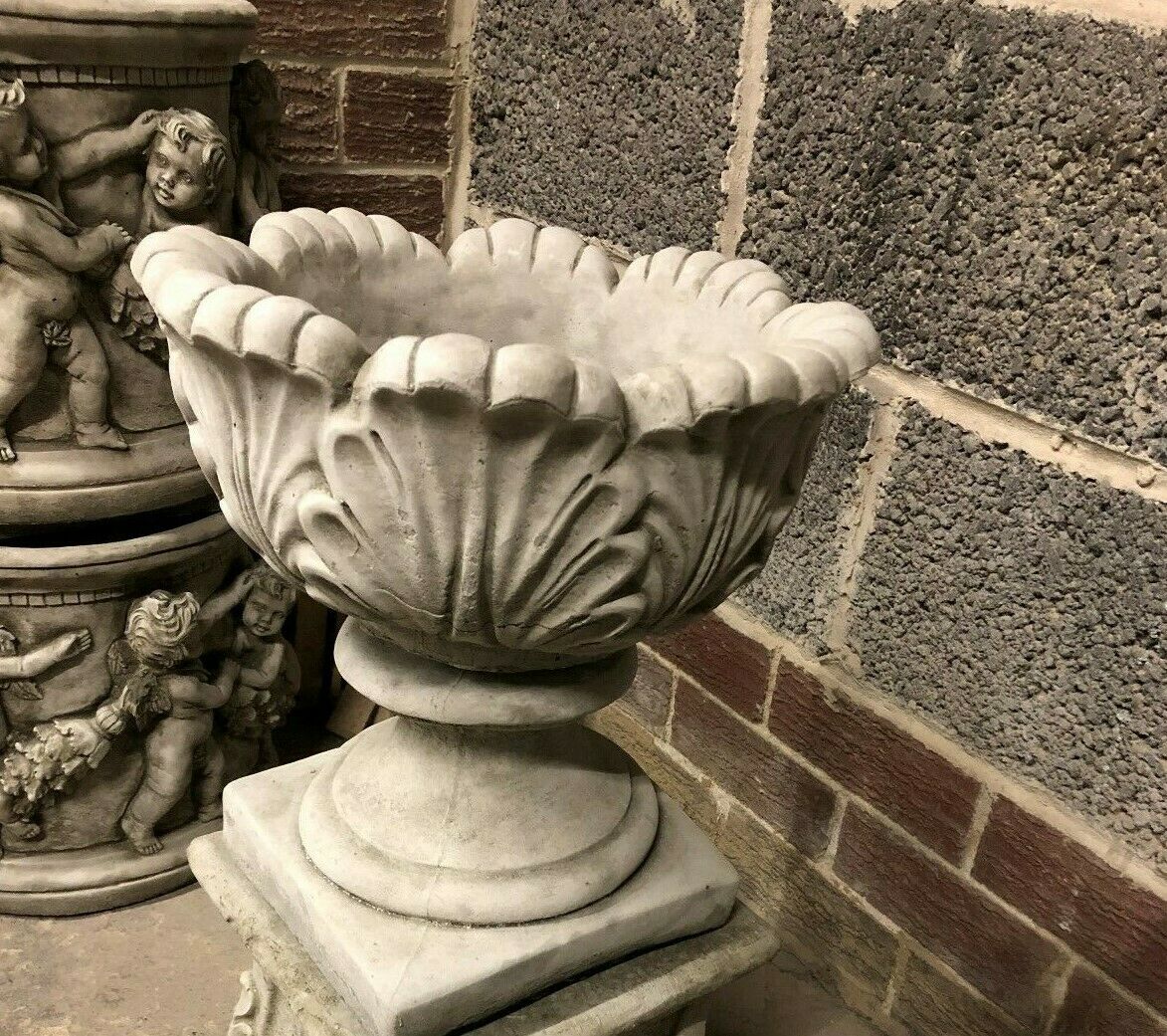 Side angle of the antique-finished Small Tulip Garden Planter, highlighting its elegant curves and durable stone construction.