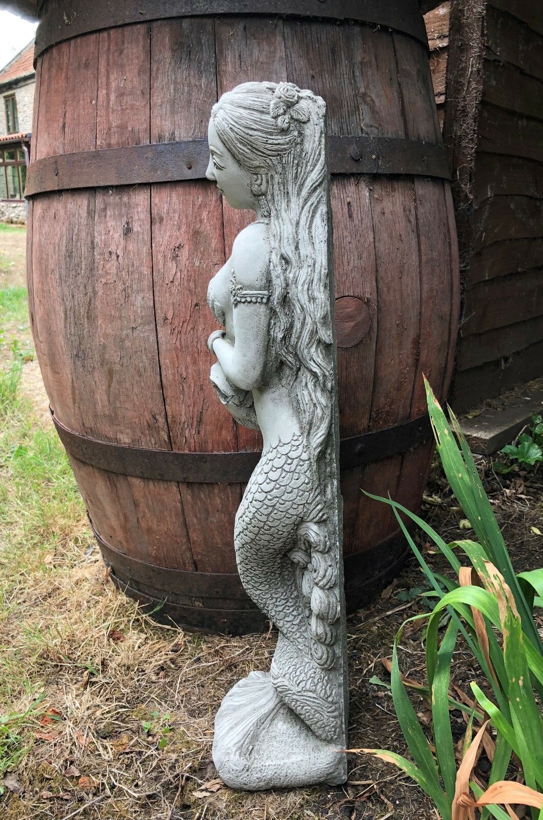 Side profile of Mermaid Garden Ornament with long flowing hair and textured tail, ideal for pondside or outdoor garden decor.