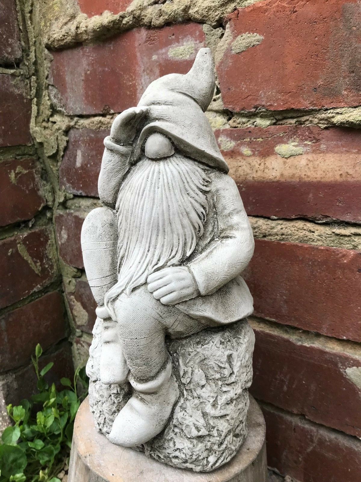 Garden Gnome Ornament - Stone Searching design featuring a bearded dwarf sitting on a rock, made from durable weatherproof limestone.