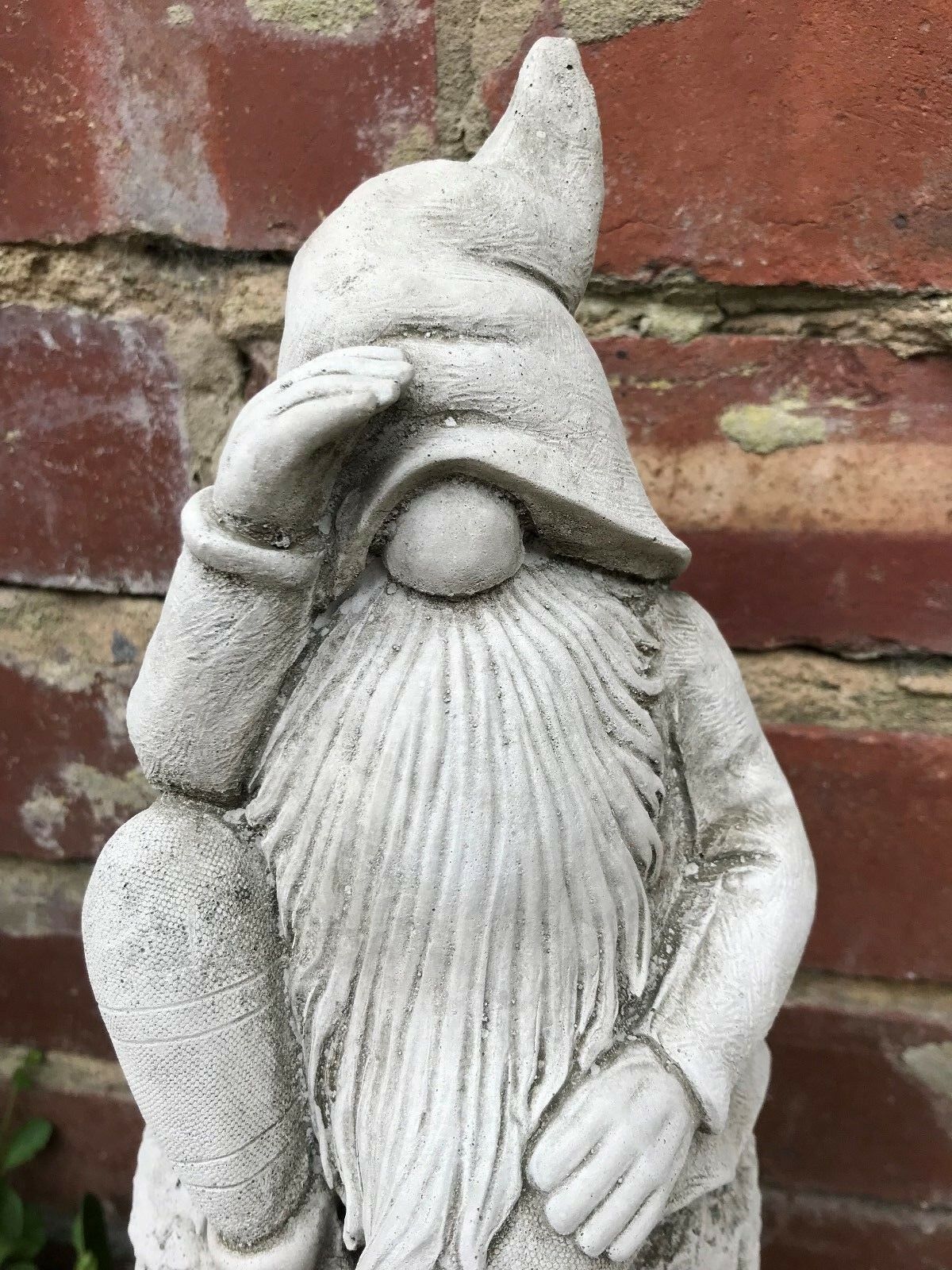 Close-up of Stone Searching Gnome Garden Ornament showing detailed beard, hat, and textured limestone finish for outdoor decoration.
