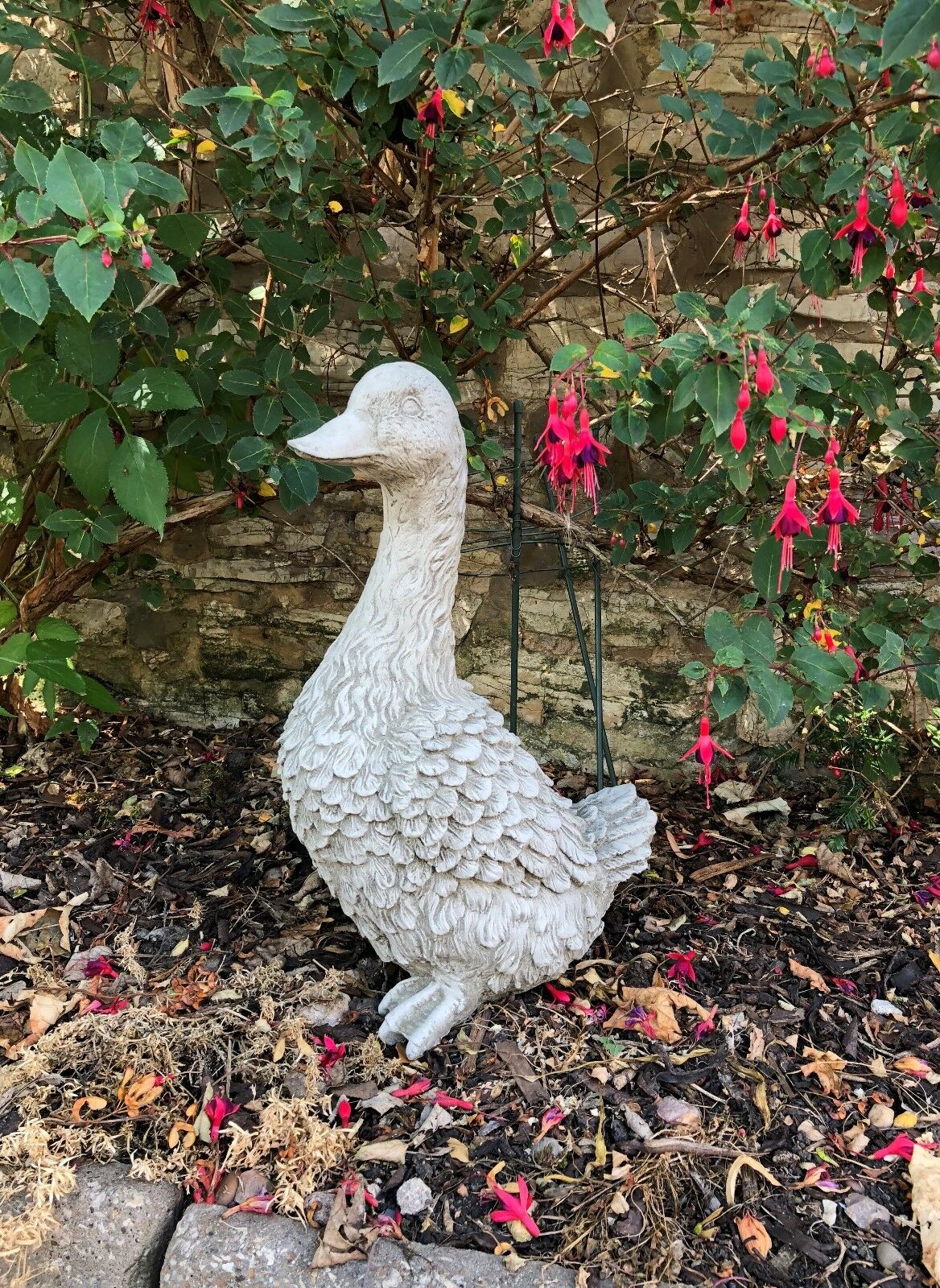 Goose Garden Statue - Stone Goose Decor in a landscaped garden bed. Handmade and weather-resistant for year-round outdoor use.
