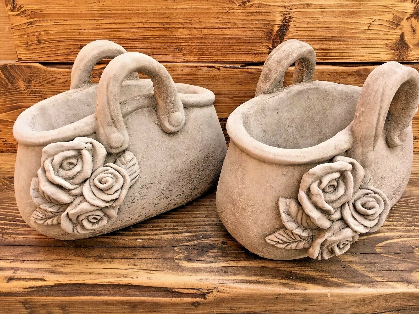 Stone handbag planters with rose design, made from durable limestone chippings. Elegant garden flower pots ideal for outdoor decoration.