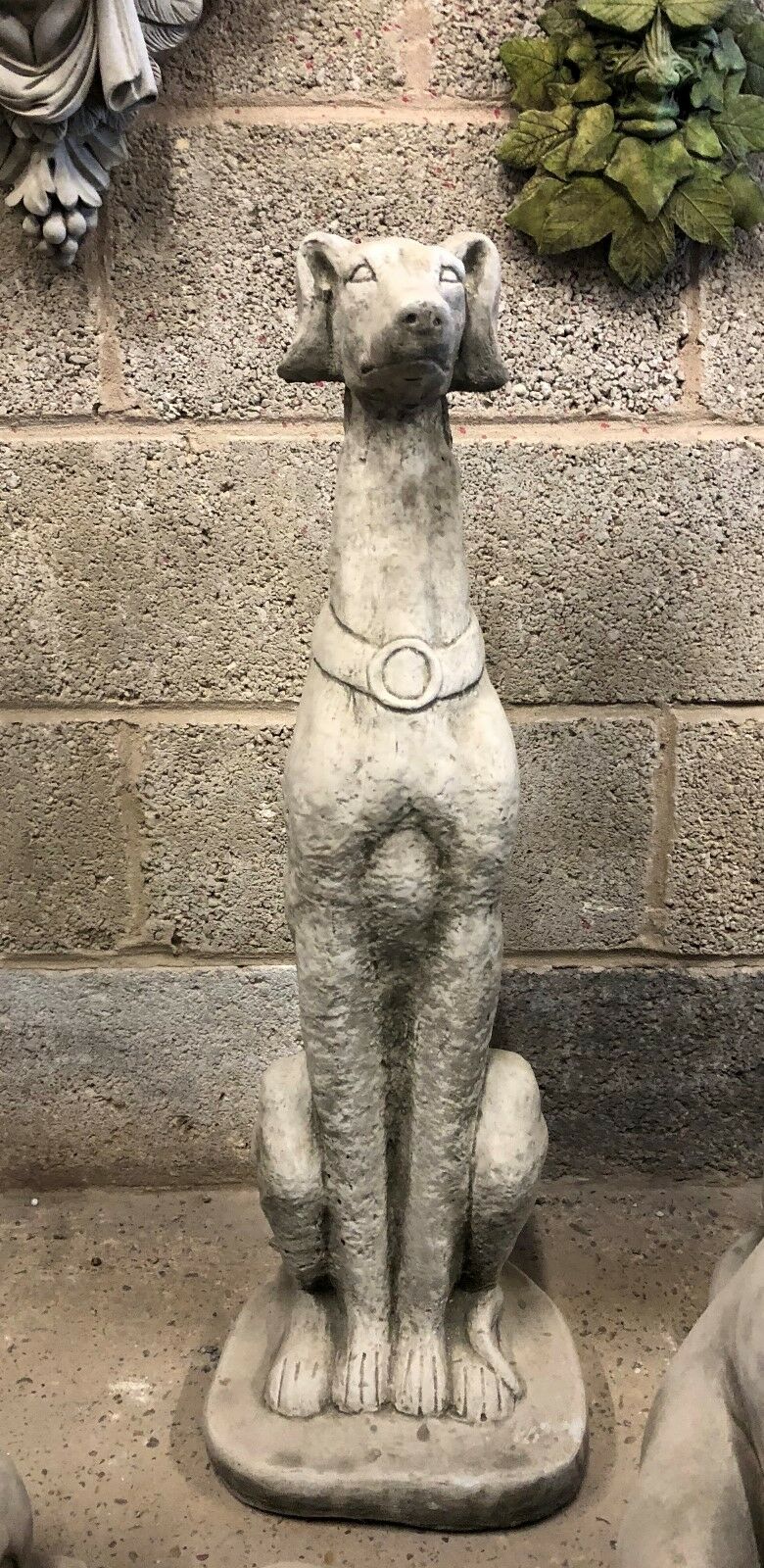 Single Saluki dog statue in sitting pose, crafted from solid stone. Perfect as a decorative garden ornament or pet memorial sculpture.