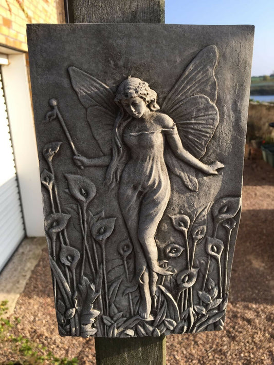 Fairy Garden Wall Plaque in limestone finish featuring a detailed fairy with wings among lilies. Ideal for outdoor garden or patio decor.