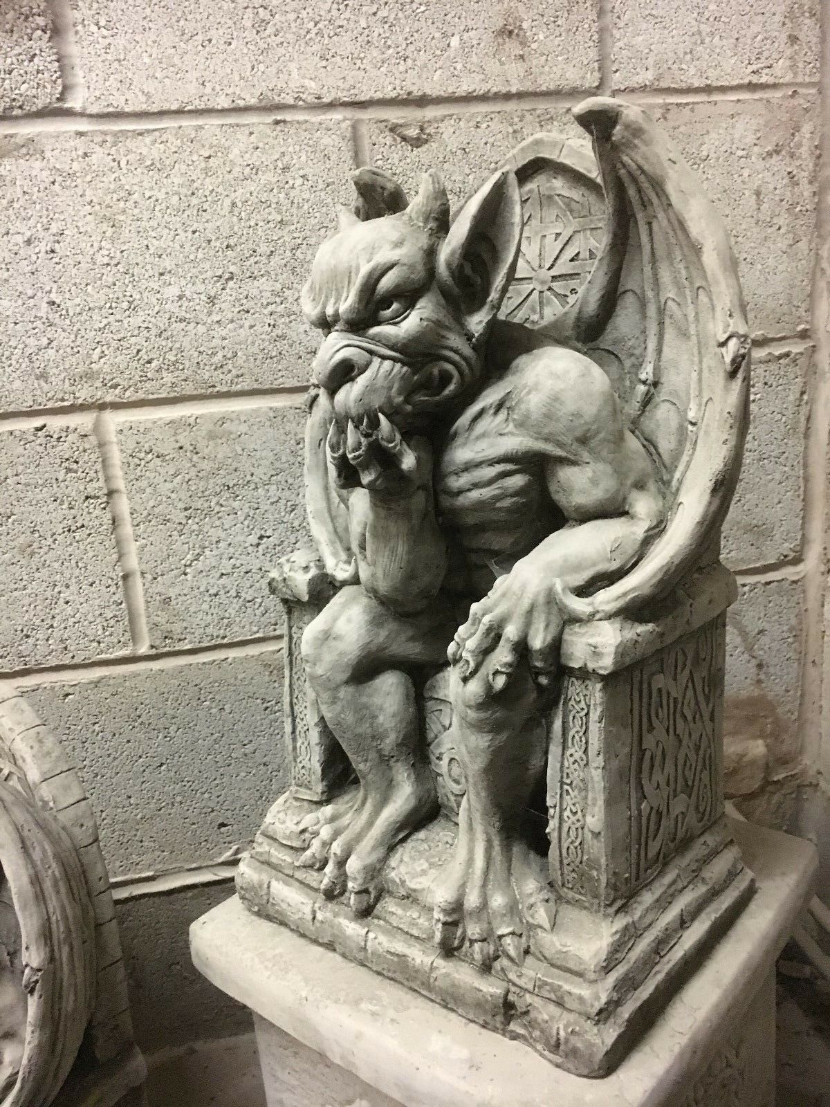 Side view of King Gargoyle Stone Statue - Weather Resistant Garden Art highlighting throne carvings and winged back, perfect for gothic garden themes.