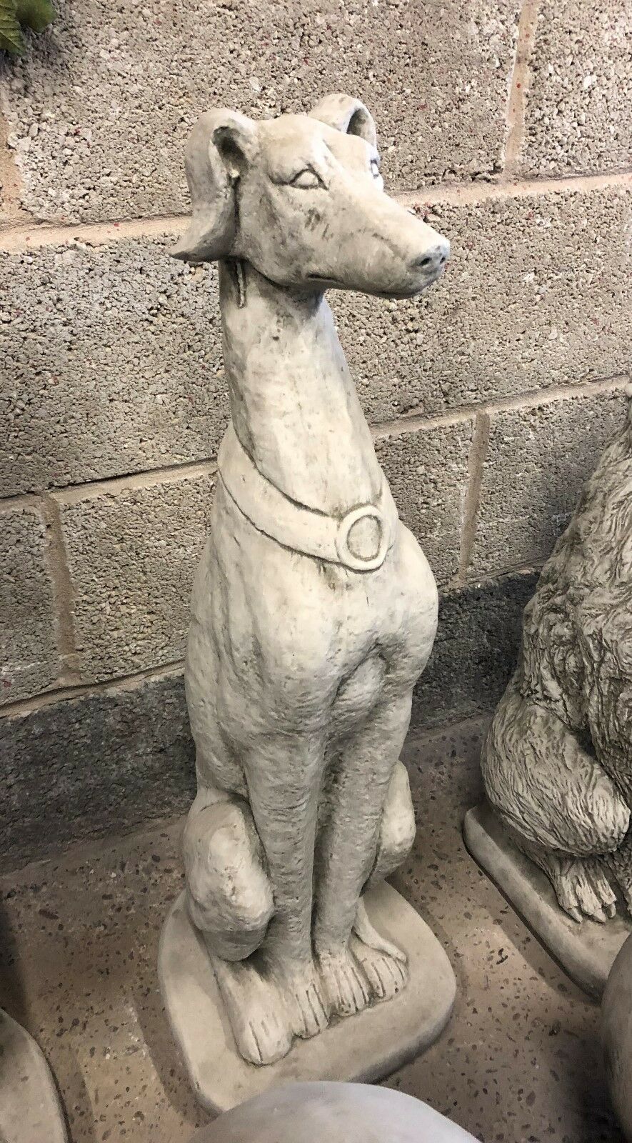 Detailed limestone Saluki dog statue with elegant features, designed for outdoor garden display. Durable and weatherproof garden sculpture.