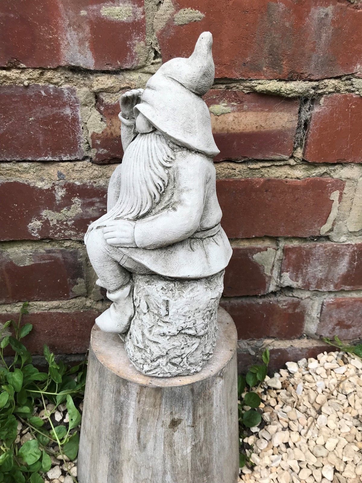 Angled side view of Stone Searching Garden Gnome Ornament with rustic limestone texture, perfect for garden or yard decor.