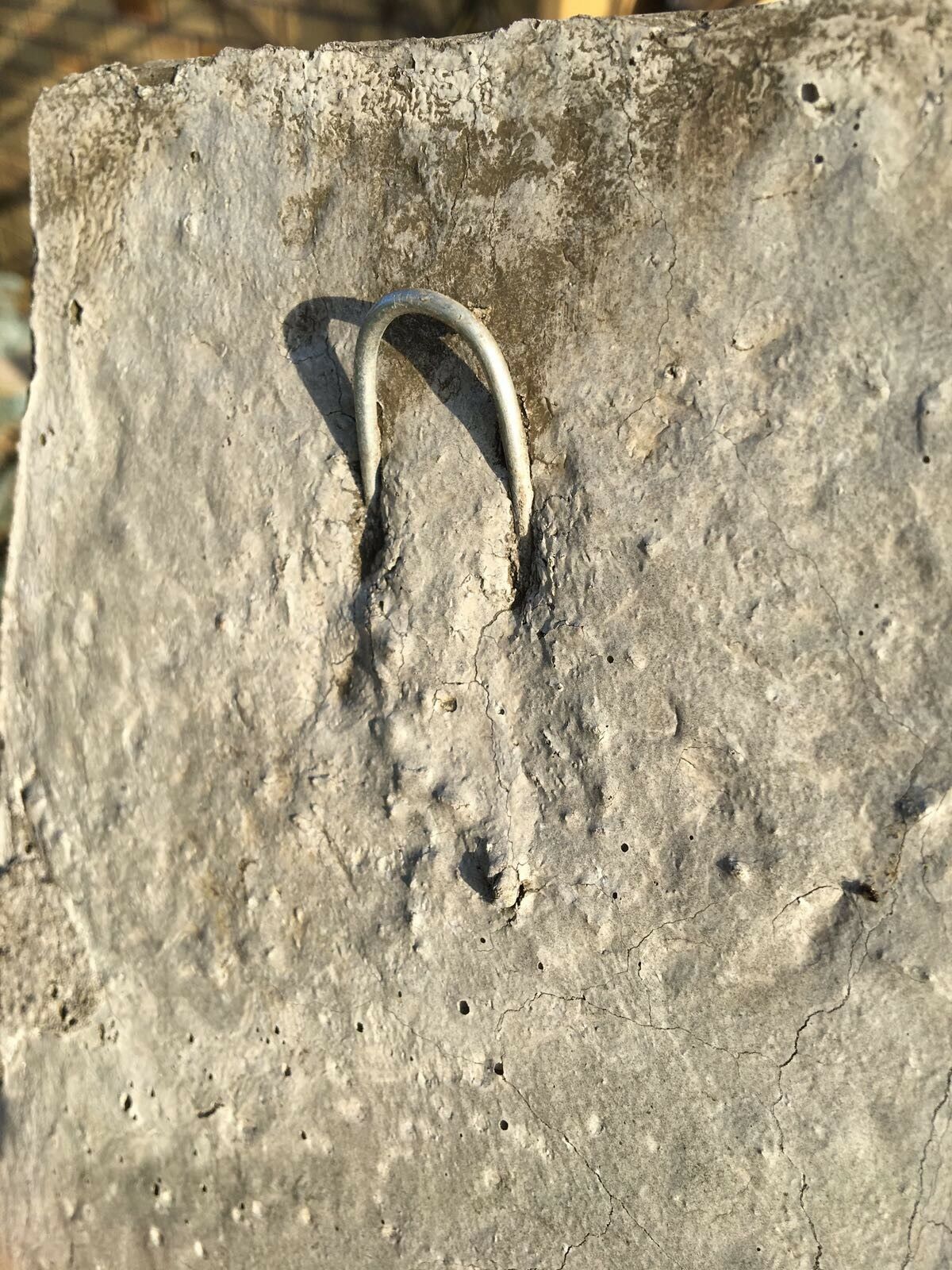 Back view of Fairy Garden Wall Plaque showing sturdy metal hook for easy wall mounting. Durable limestone texture ensures outdoor longevity.
