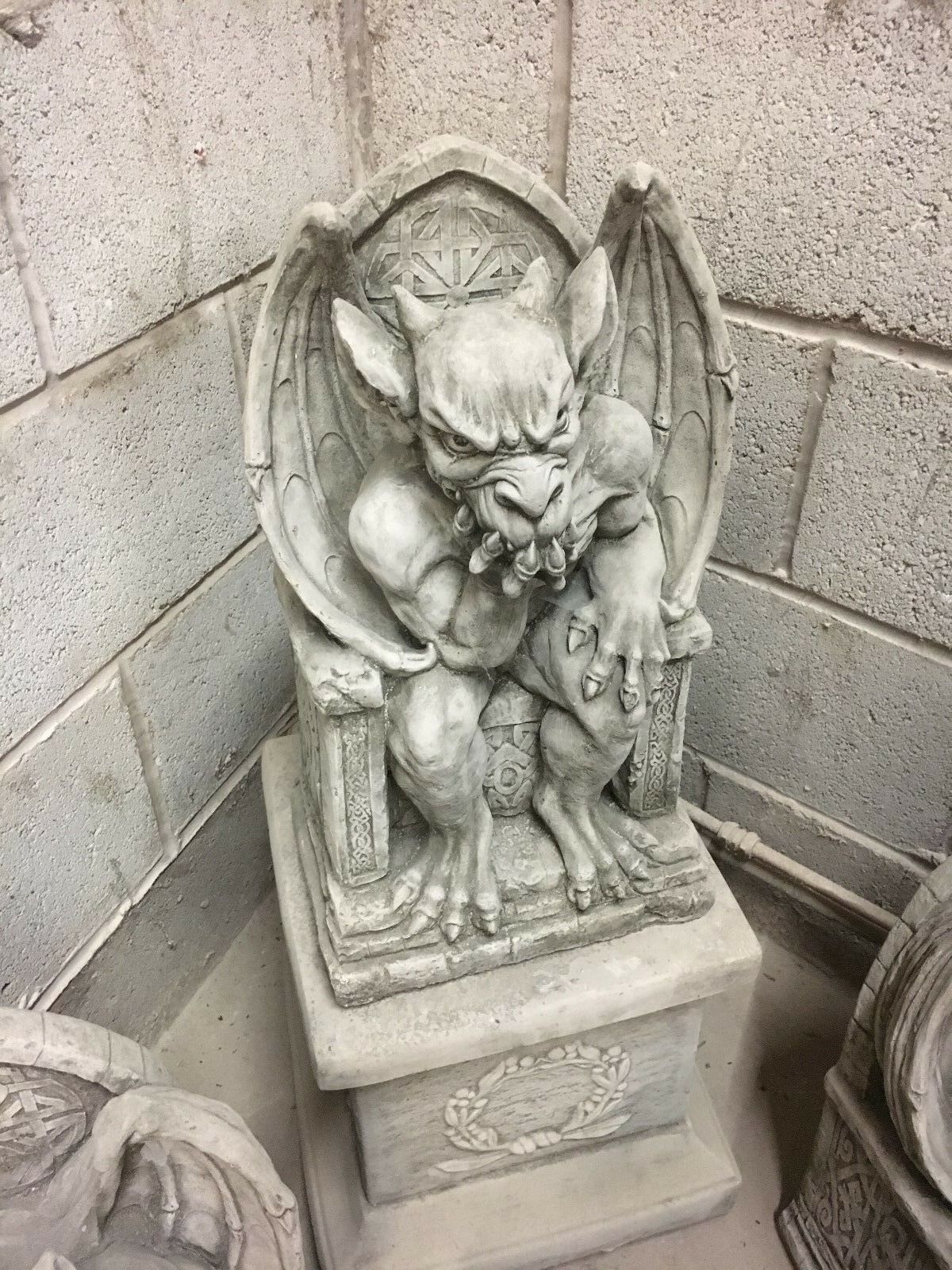 Angled view of King Gargoyle Stone Statue - Weather Resistant Garden Art emphasizing throne base and muscular form, ideal for patio or lawn ornamentation.