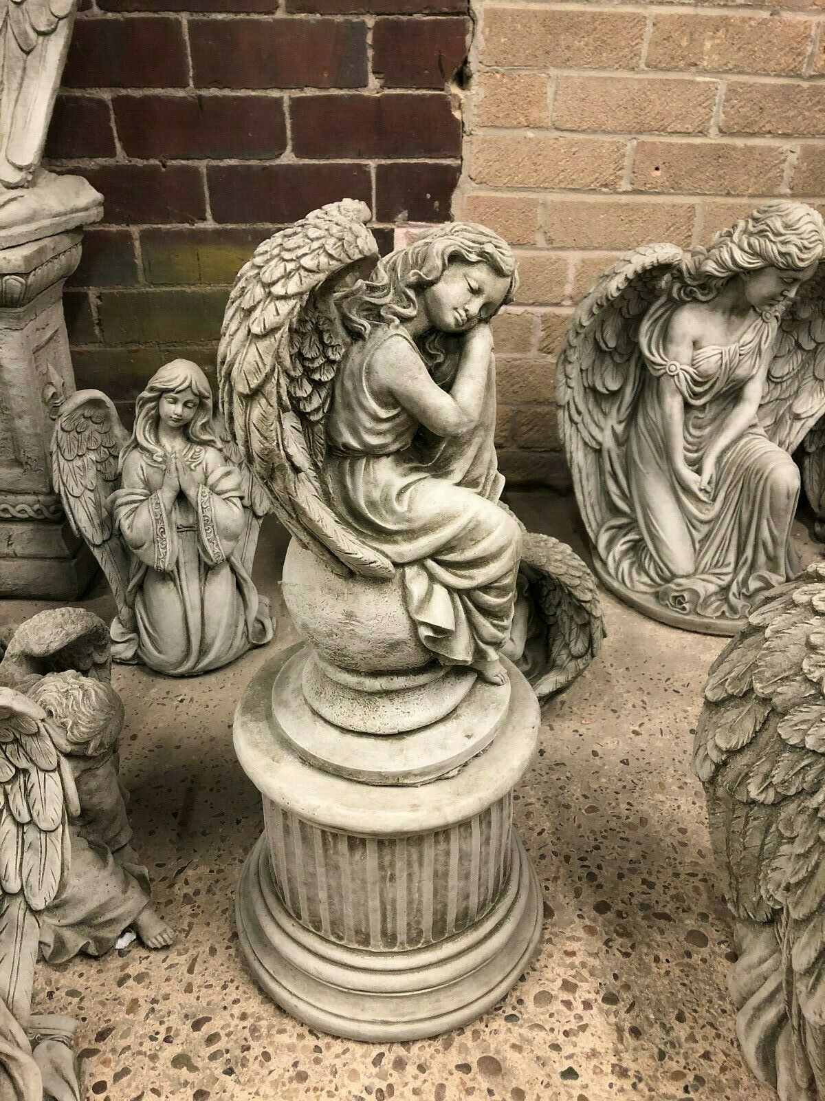 Full view of Stone Angel Garden Statue on Ball Plinth, perfect for outdoor garden ornament or memorial, sculpted in solid limestone.