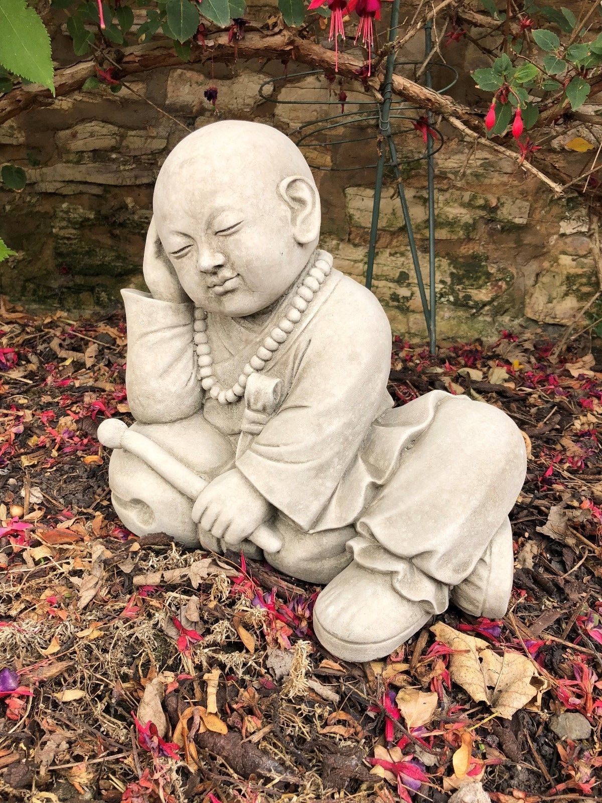 Decorative Stone Resting Monk Sculpture Garden Ornament with detailed robe and prayer beads, perfect for enhancing tranquil garden spaces.