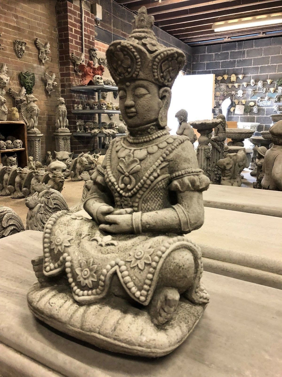 Serene Buddha Statue Garden - Meditating Stone | Peaceful Decor. Angled view of stone Buddha statue showcasing detailed craftsmanship and serene expression.